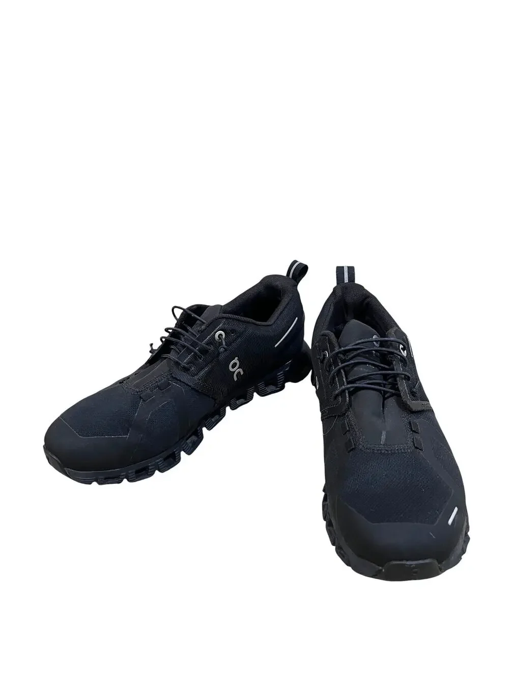 On Cloud waterproof running shoes for women in solid black.
